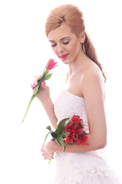 Beautiful bride with red tulips