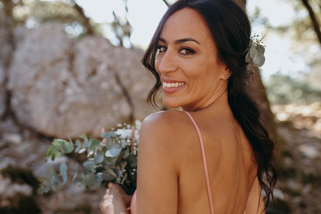 Beautiful bridesmaid holding a floral bouquet