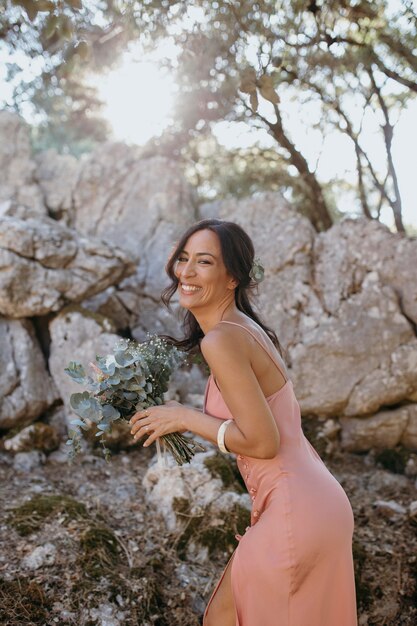 Beautiful bridesmaid holding a floral bouquet