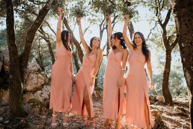 Free photo beautiful bridesmaids in pretty dresses outdoors