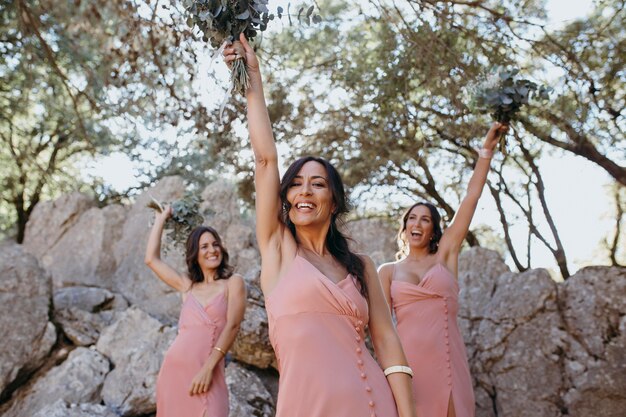 Beautiful bridesmaids in pretty dresses outdoors