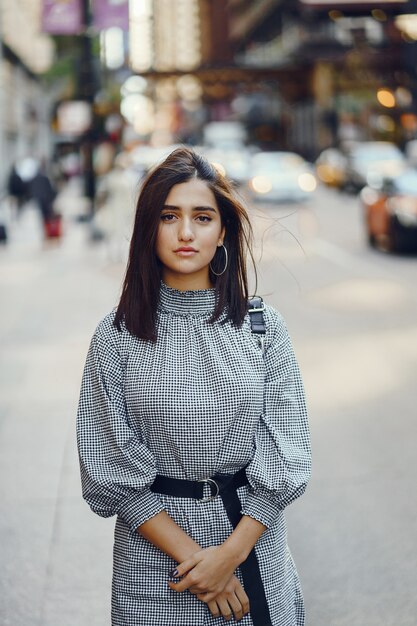 beautiful brunette girl exploring the city during autumn