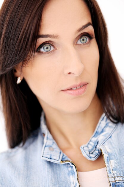 Beautiful brunette in jeans clothes