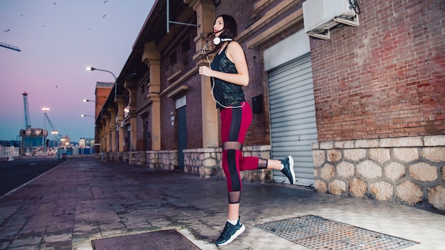 Free photo beautiful brunette running on sidewalk