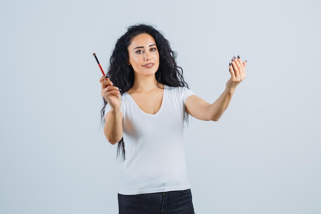 Beautiful brunette woman applying makeup