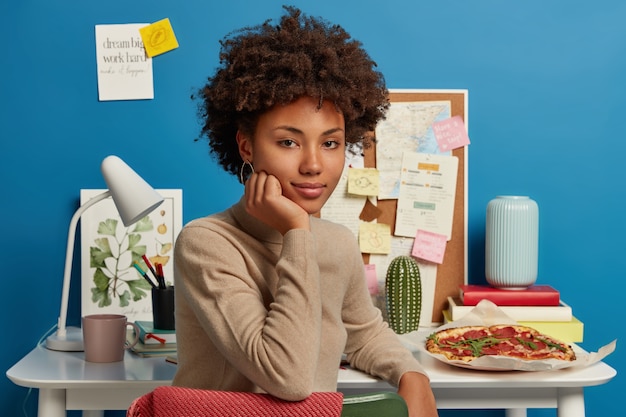 Beautiful brunette woman staying in her workplace