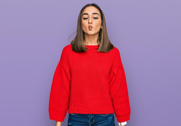 Free Photo beautiful brunette woman wearing casual winter sweater making fish face with lips crazy and comical gesture funny expression