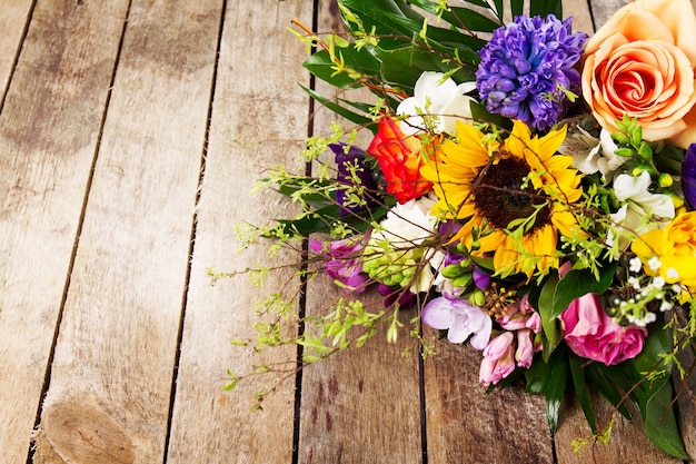 Beautiful bunch of flowers on wooden background. Horizontal. View from above.