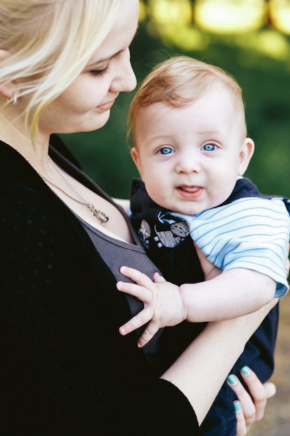 Beautiful business woman mother posing with adorable baby son