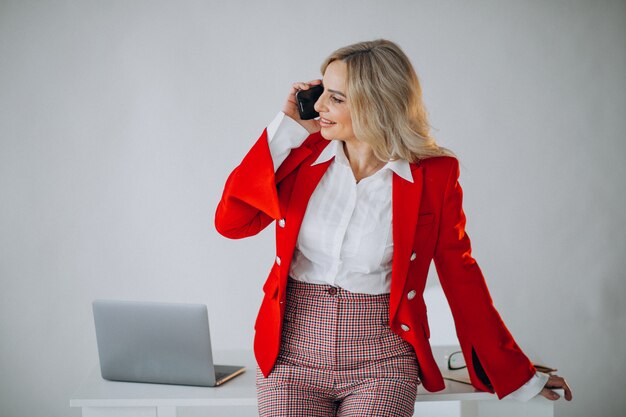 Beautiful business woman at the office talking on the phone