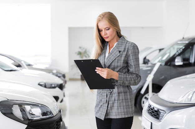 Beautiful businesswoman looking at a clipboard