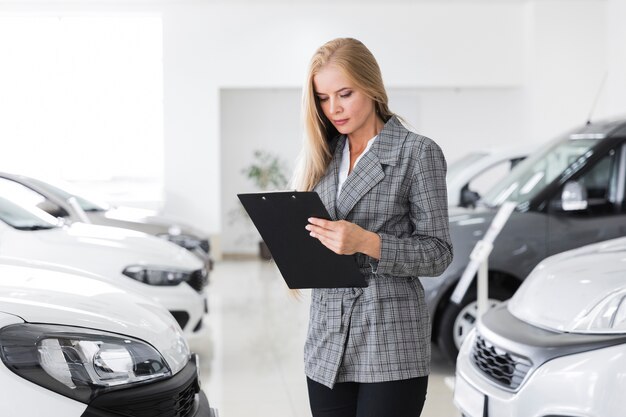 Beautiful businesswoman looking at a clipboard