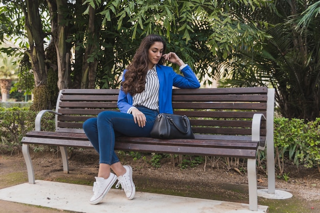 Beautiful businesswoman thinking in the park