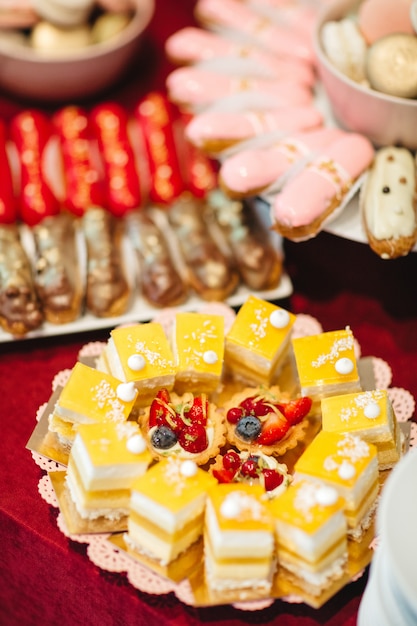 Beautiful cakes are on a plate on a festive table