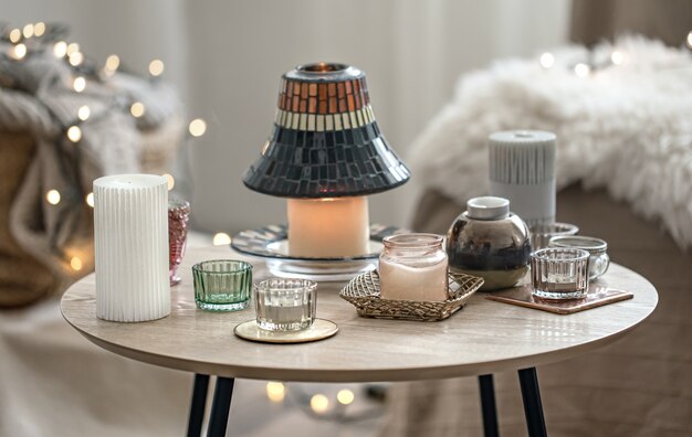 Beautiful candles in the Scandinavian style on a blurred background with bokeh.