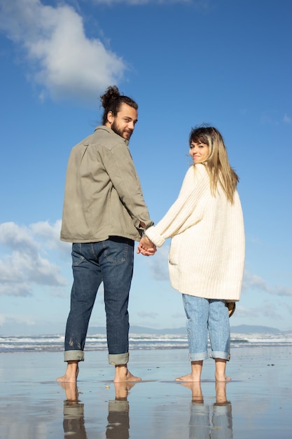 Beautiful Caucasian couple spending time at the beach