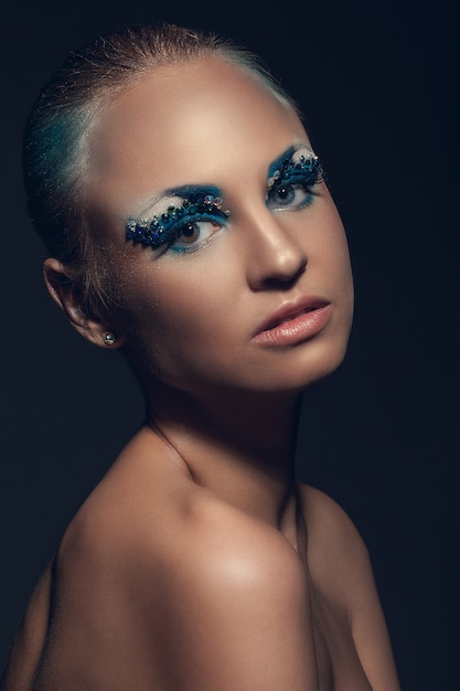 Beautiful caucasian woman with artistic makeup