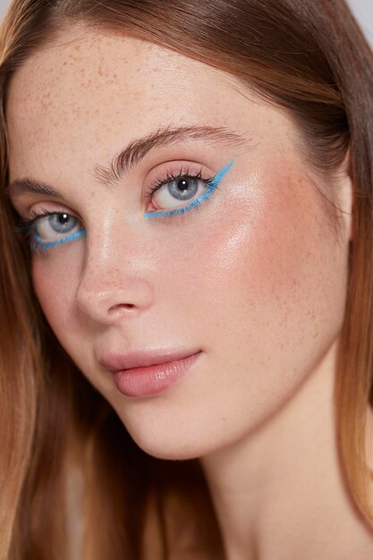 Beautiful caucasian woman with blue eyeliner