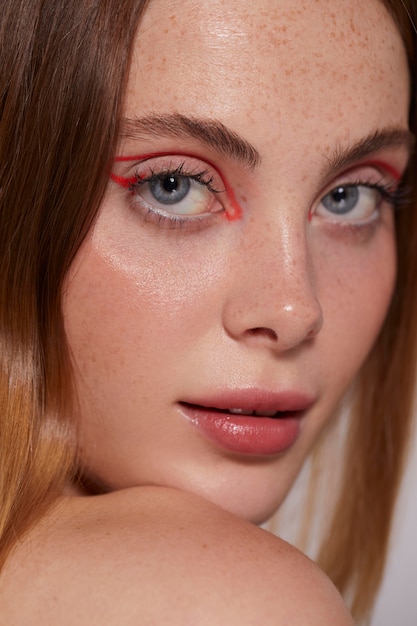 Beautiful caucasian woman with red eyeliner