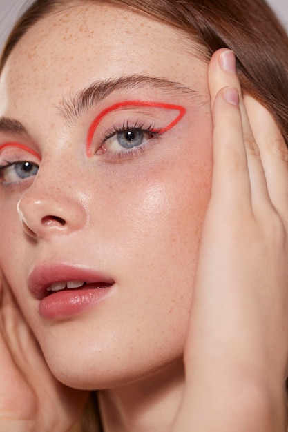 Beautiful caucasian woman with red eyeliner