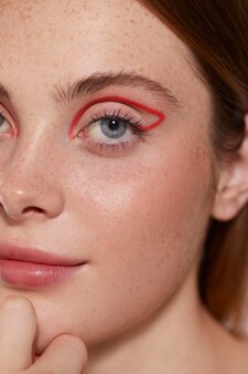Beautiful caucasian woman with red eyeliner
