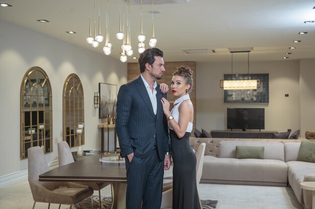 Beautiful charming couple standing in the room and looking at the camera