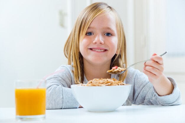 Beautiful child having breakfast at home.