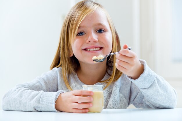 Beautiful child having breakfast at home.