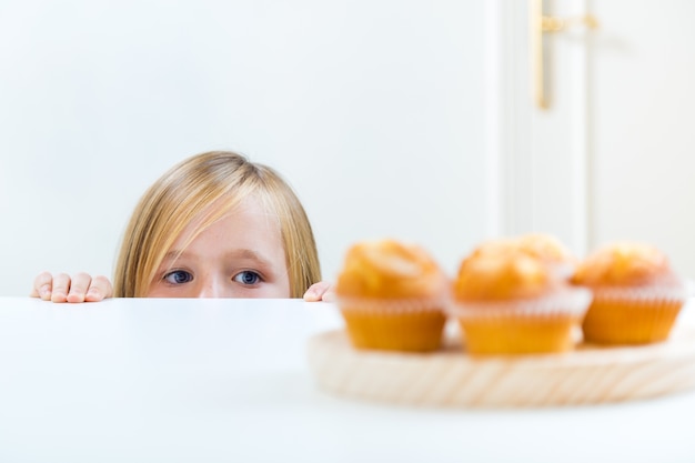 Beautiful child having breakfast at home.