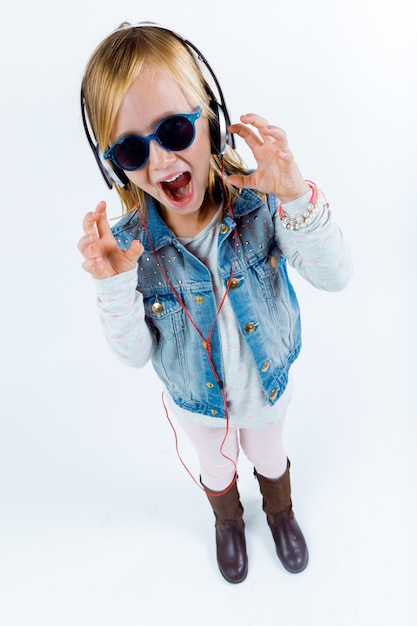 Beautiful child listening to music with digital tablet.