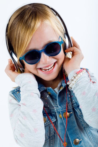 Beautiful child listening to music with digital tablet.