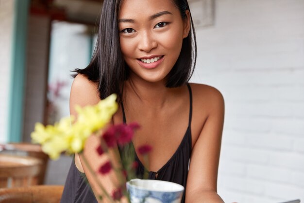 beautiful Chinese woman portrait with bobbed hairstyle, poses in cozy room