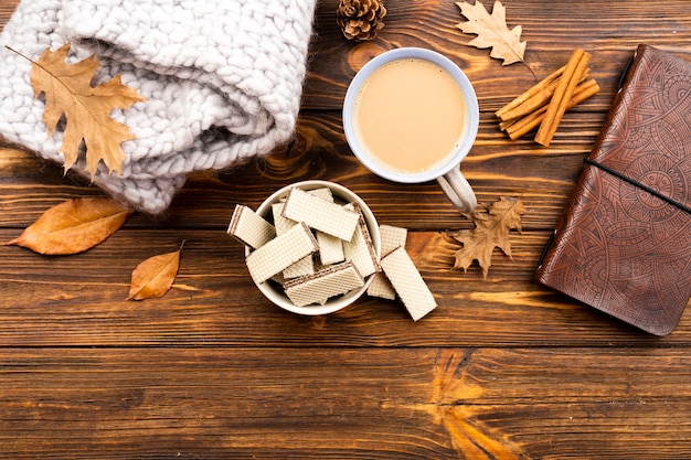 Beautiful coffee and wafers layout on wooden background