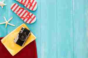 Free photo beautiful composition with summer stuff on a blue wooden background with copyspace