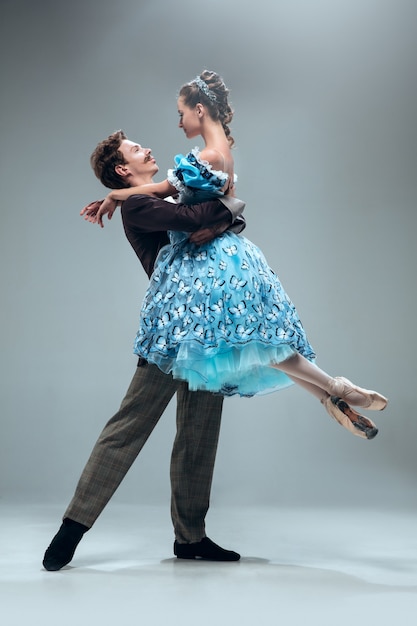 Beautiful contemporary ballroom dancers isolated on grey  background.