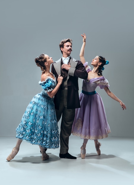 Beautiful contemporary ballroom dancers isolated on grey studio wall