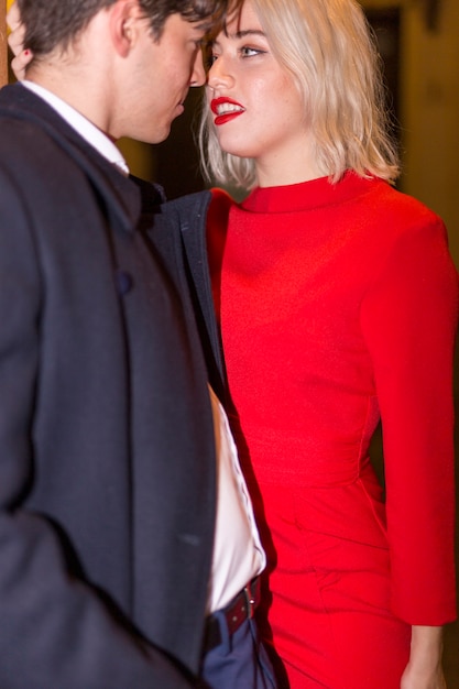 Beautiful couple being dressed in elegant clothes