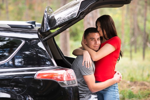 Beautiful couple in car medium shot