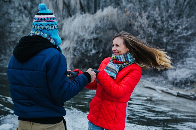 Beautiful couple having fun on the pier at the lake