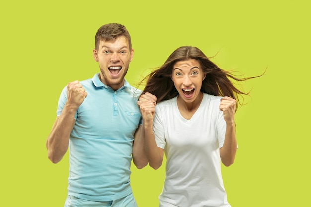 Beautiful couple isolated on green studio background