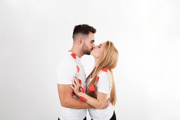 Beautiful couple kissing on white background