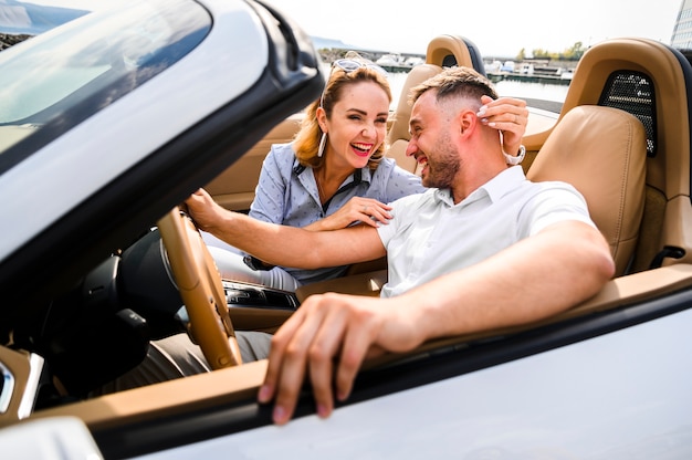 Beautiful couple laughing in car