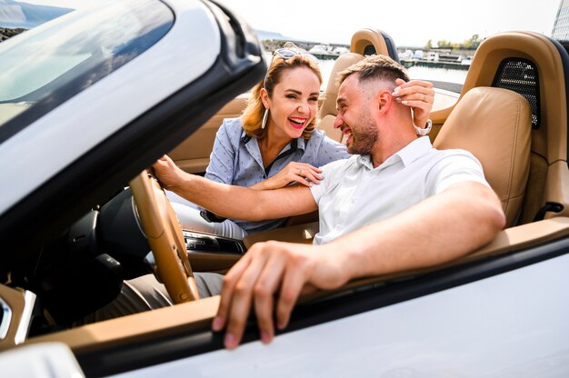 Beautiful couple laughing in car
