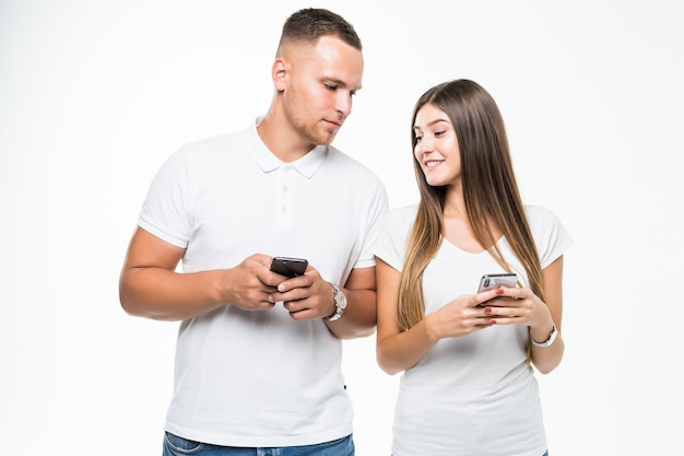 Beautiful couple looking into each other mobile phone isolated on white