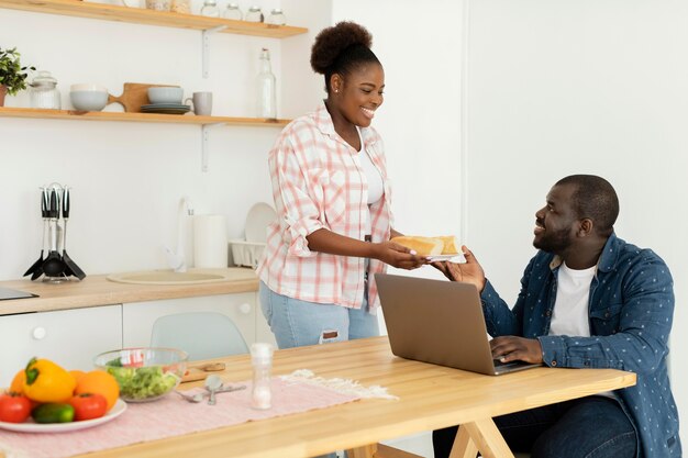 Beautiful couple looking at their laptop