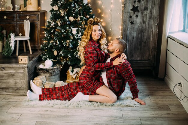 Beautiful couple in love relaxes on the floor in the living room together