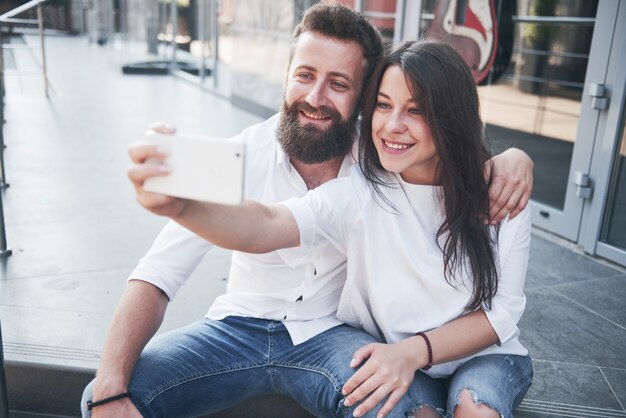 A beautiful couple makes a photo outdoors