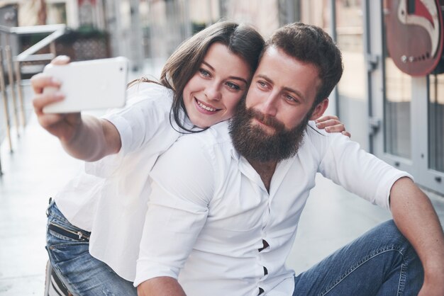 A beautiful couple makes a photo outdoors