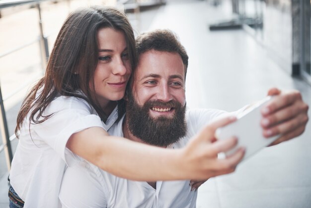 A beautiful couple makes a photo outdoors.