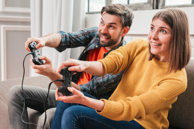 Beautiful couple playing video games on console